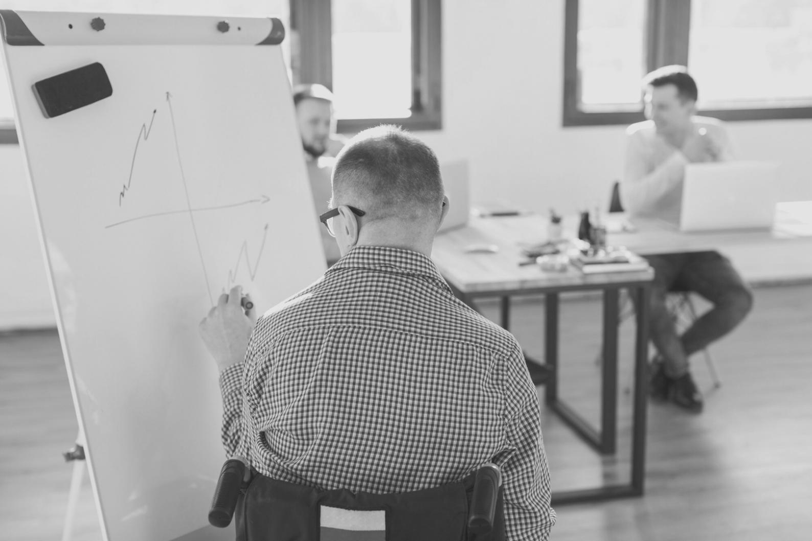 Professional meeting with financial charts showing seasonal business trends and budget adjustment strategies